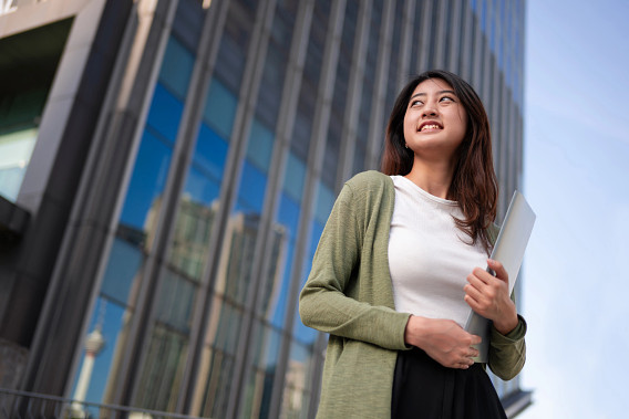 Student with laptop in financial district