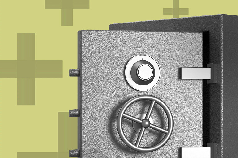 Close-up of a heavy metal safe with a circular combination dial and wheel handle on the door, shown against a light green background with abstract plus-shaped patterns.